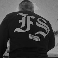 a black and white photo of a man with the letter fs on his back